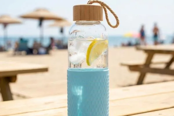 A wide-mouth glass bottle with a stainless steel and bamboo lid, showing the silicone seal.