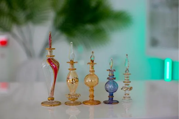 A classic, jewel-encrusted perfume bottle with colorful enamel details