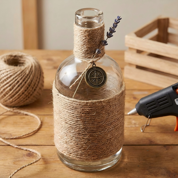 A spirit bottle wrapped in rustic jute twine with a small charm attached
