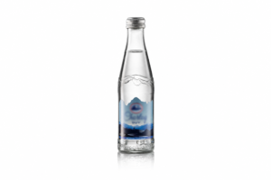 Clear glass water bottle decorated with a full-color decal showing a mountain landscape